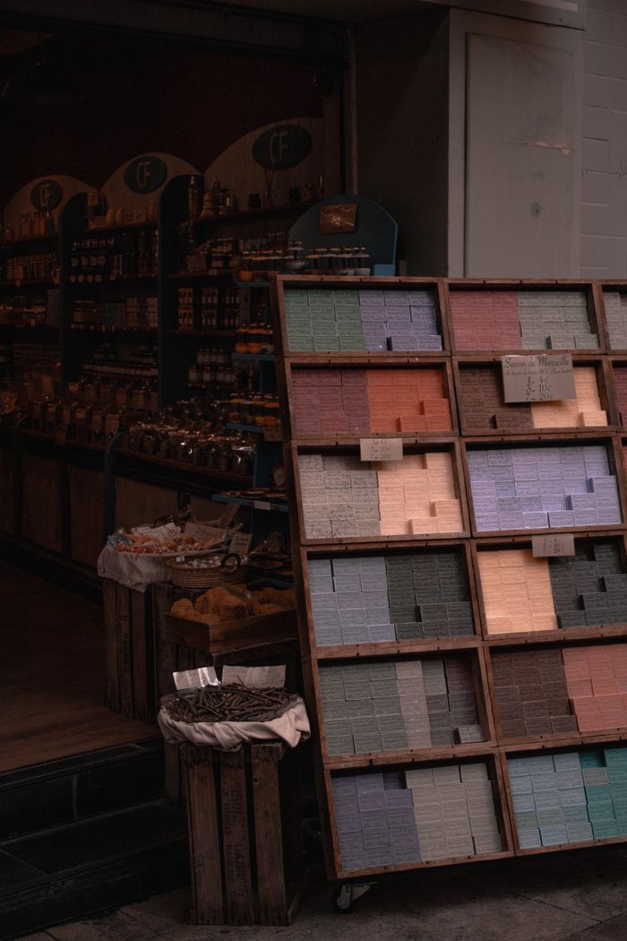 about-02 Colorful soaps on display at an urban street market stall, offering a variety of shades and textures.