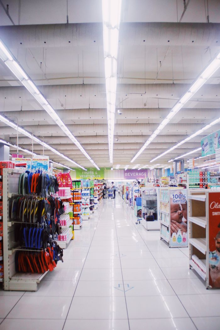 services-03 Interior of light spacious hallway among shelves with assorted products in contemporary supermarket